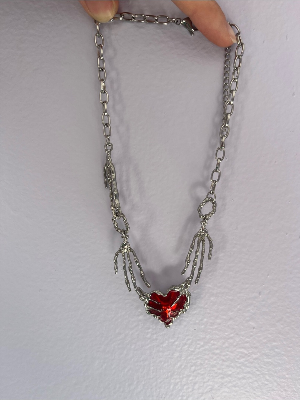 Silver Skeleton Hands Necklace with Red Heart Pendant